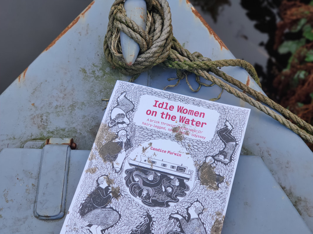 A graphic novel titled Idle Women on the water resting on the front of a muddy narrowboat 